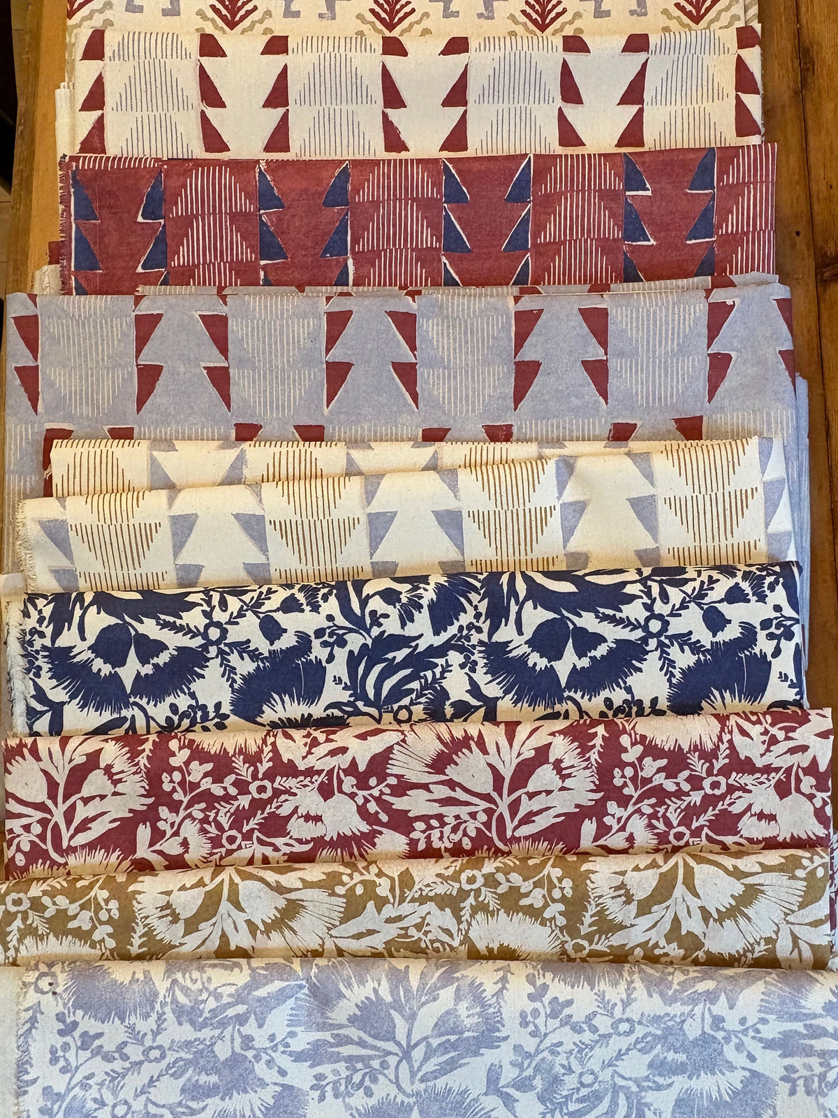 To Pastures New Fabric Collection folded on a table