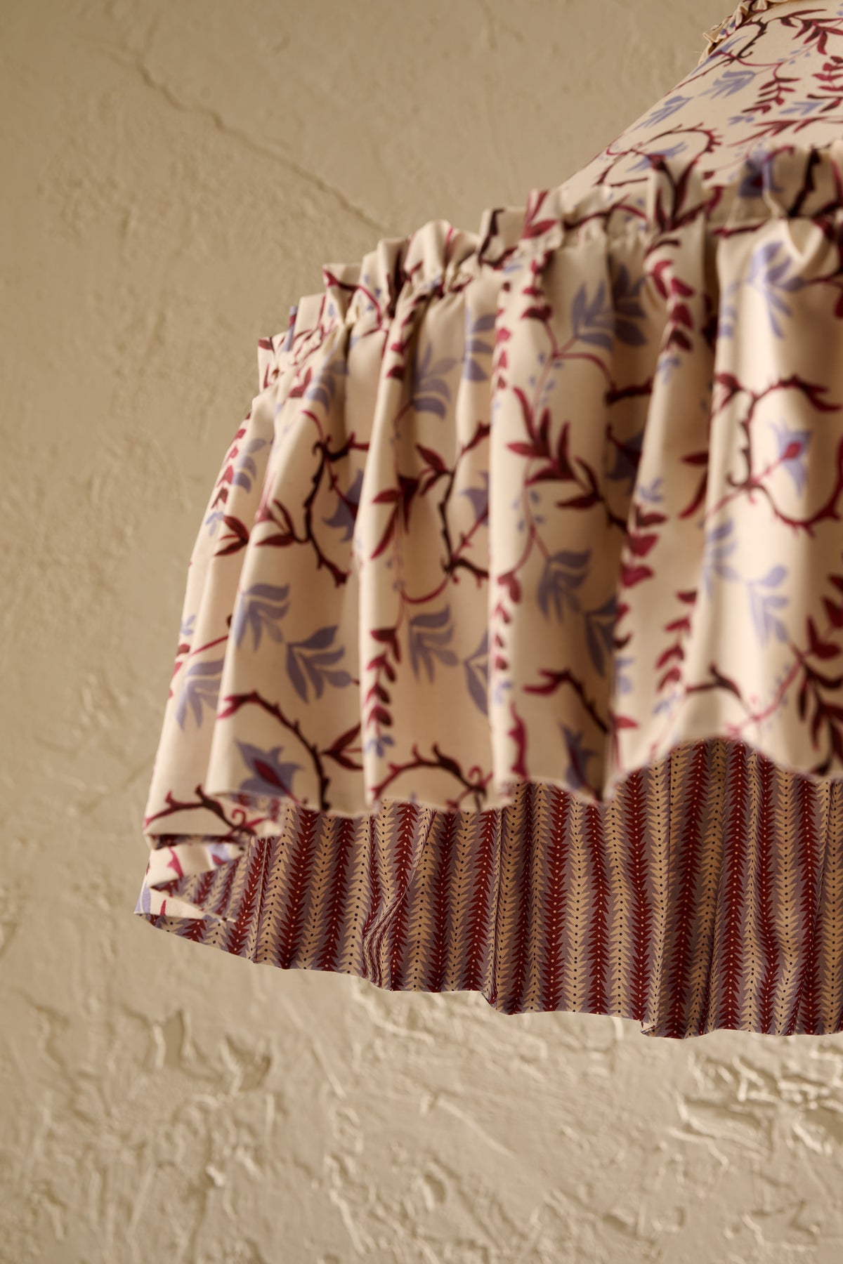 Daunder Ruffle Statement Lampshade in Merlot & Dusty Blue, showing the hand-painted botanical print and contrasting striped lining