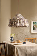Daunder Ruffle Statement Lampshade in Indigo with contrasting striped lining hanging above a dining table