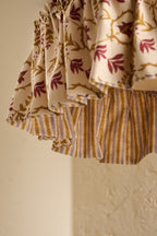 Close-up of Daunder Ruffle Statement Lampshade in Ochre & Merlot showing the gathered ruffle and contrasting striped lining