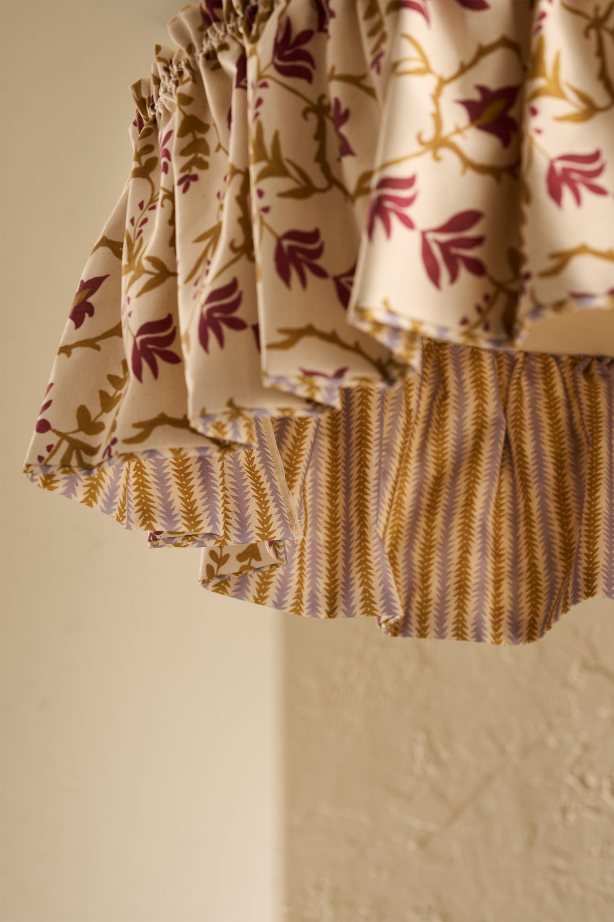 Close-up of Daunder Ruffle Statement Lampshade in Ochre & Merlot showing the gathered ruffle and contrasting striped lining