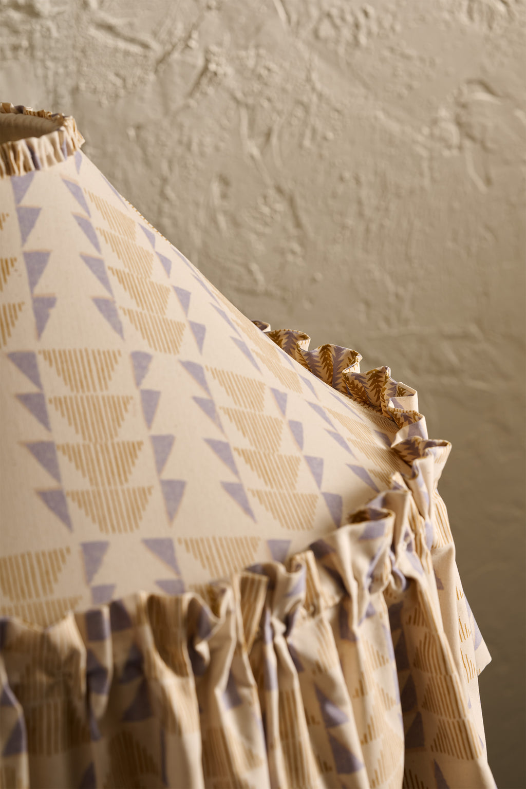 Close up detail of Ellis Ruffle Statement Lampshade in Dusty Sky & Ochre showing the ruffle trim edge and contrasting geometric lining