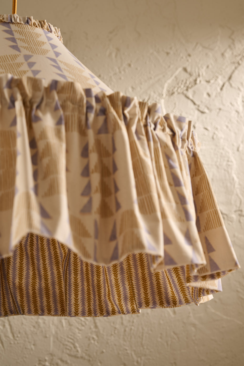 Close up detail of Ellis Ruffle Statement Lampshade in Dusty Sky & Ochre showing the ruffle trim and contrasting geometric lining