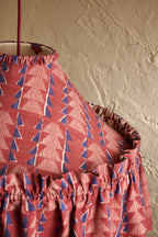 Close-up of Ellis Ruffle Statement Lampshade in Merlot showing the gathered ruffle detail from above with contrasting geometric lining