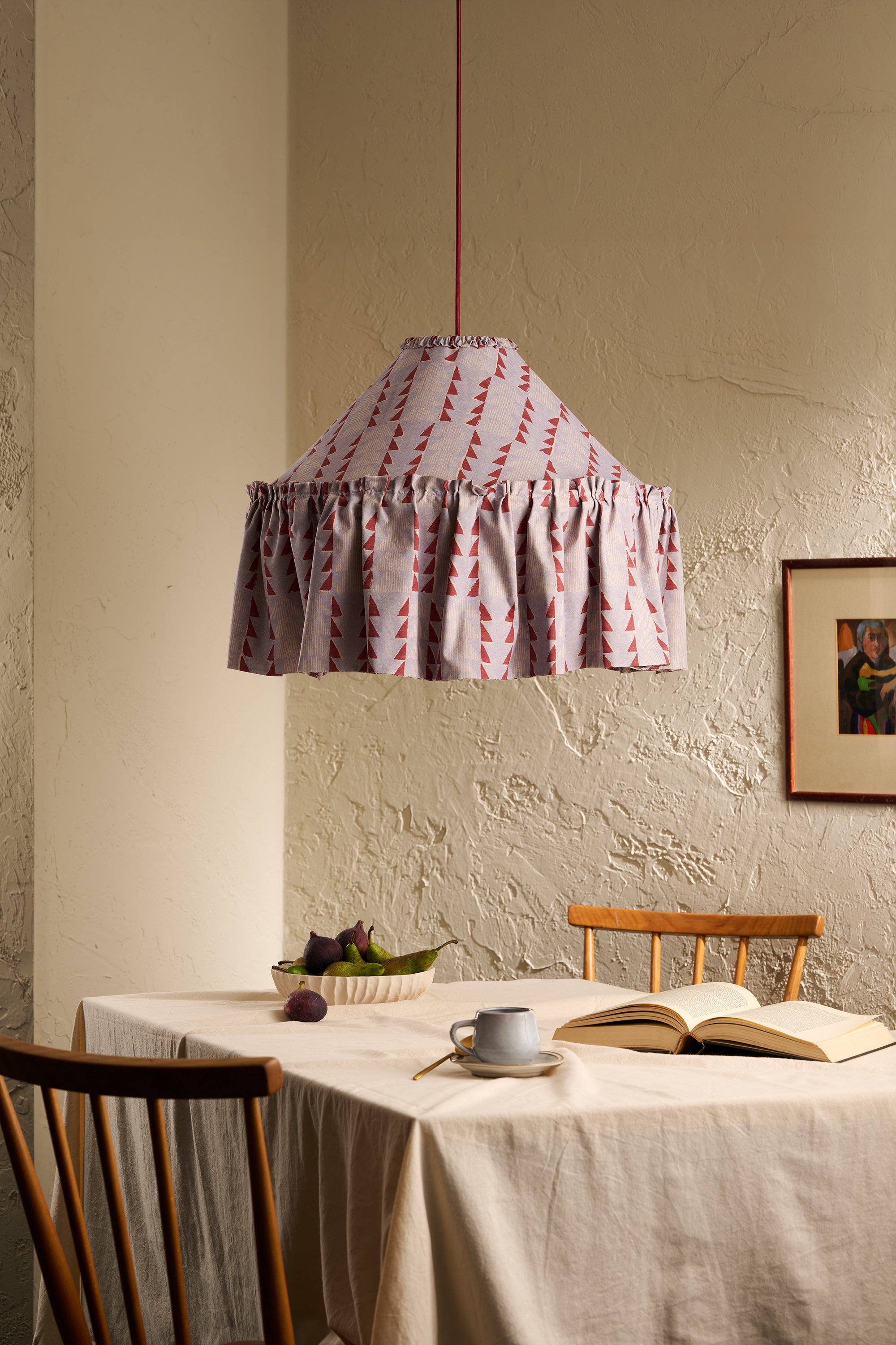Ellis Ruffle Statement Lampshade in Dusty Blue & Merlot hanging above a dining table in a warm neutral interior
